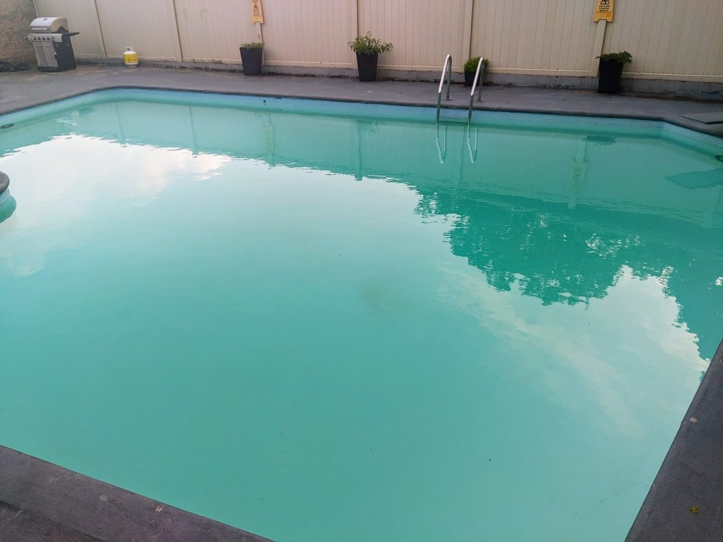 Looking into the shimmering water of a pool.